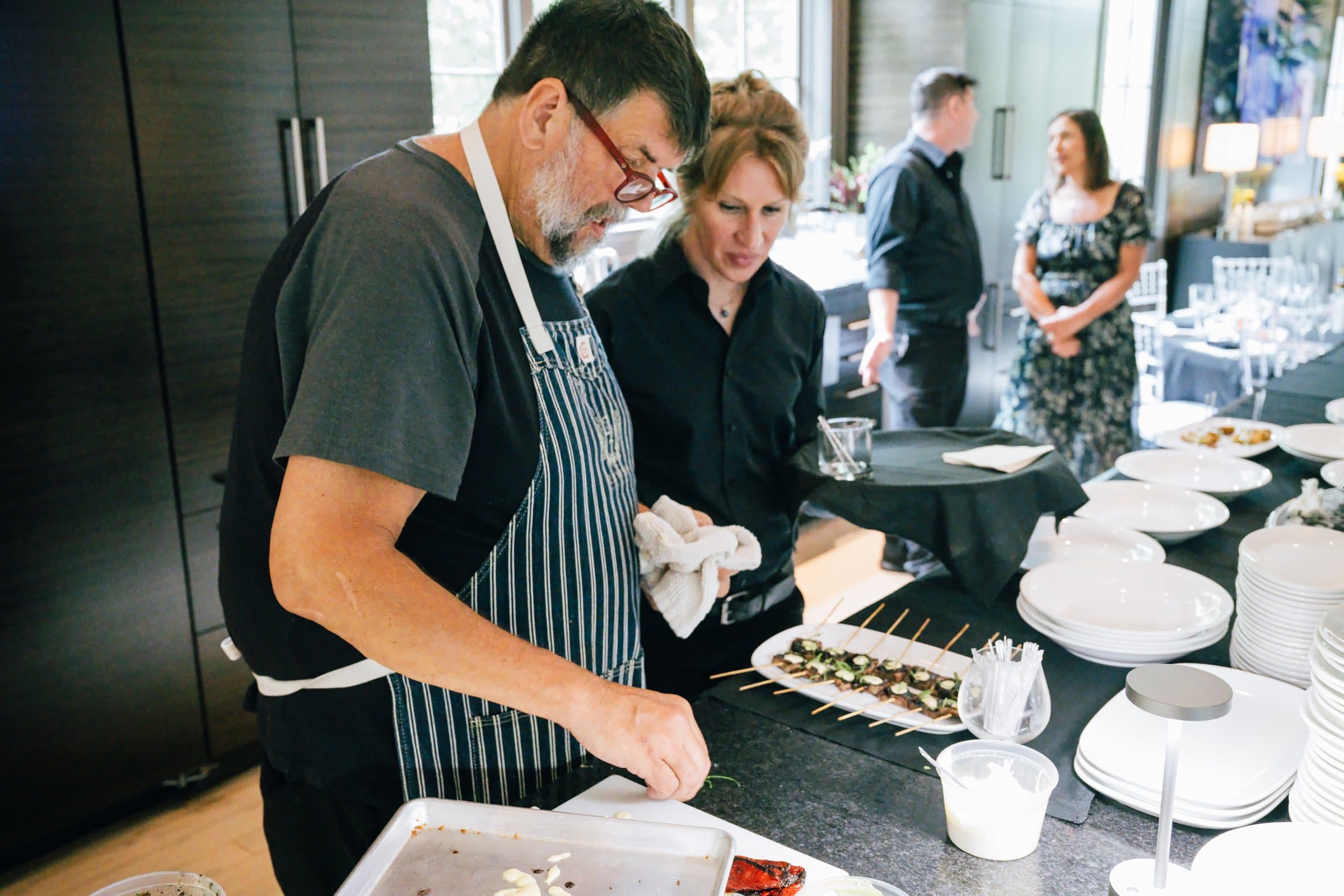A chef plating a course at a private dinner