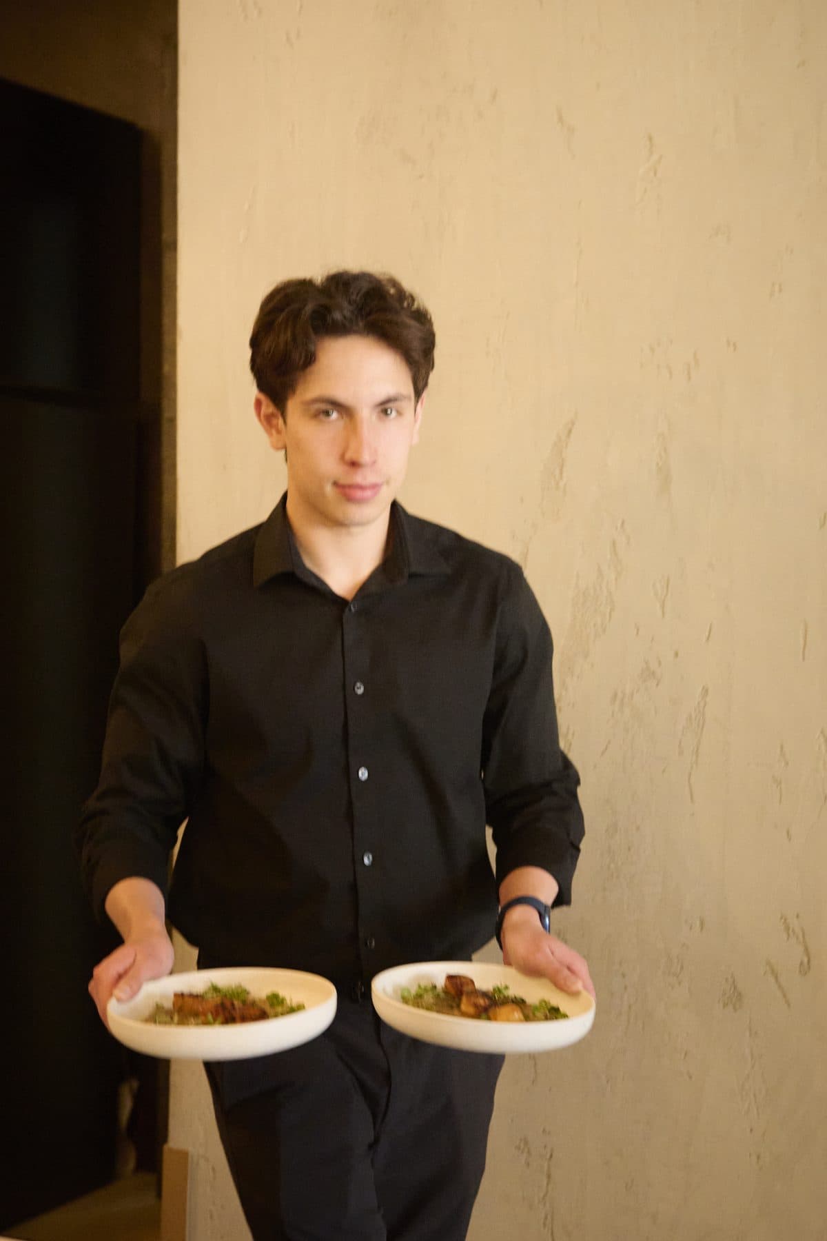 A server carrying two plated courses